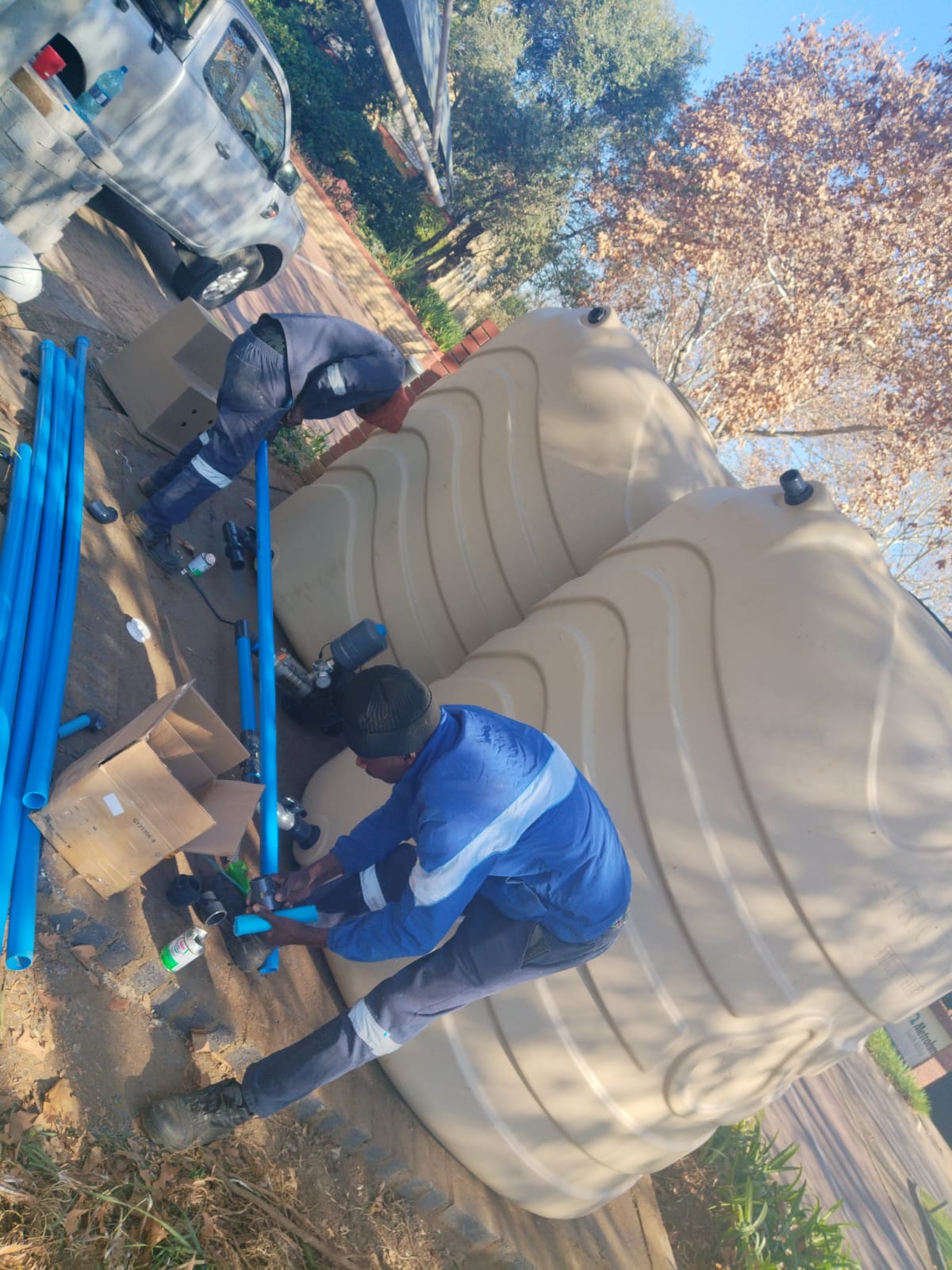 BoreFixPro crew installing tank reticulation pipework and fittings at a residential property